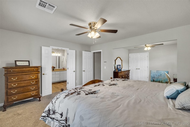 bedroom featuring a closet, carpet flooring, baseboards, and visible vents
