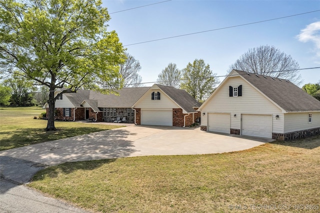 view of front of home with a shingled roof, brick siding, a front lawn, and a detached garage