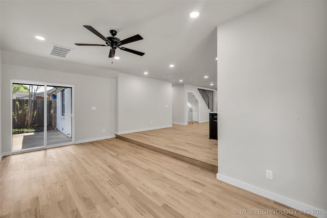 unfurnished living room featuring recessed lighting and baseboards