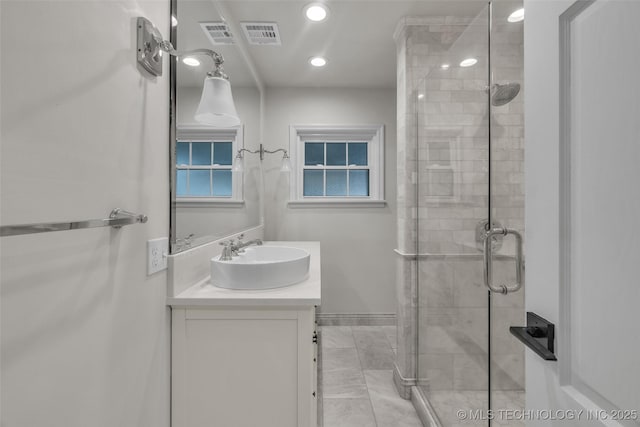 bathroom featuring vanity, baseboards, a stall shower, recessed lighting, and visible vents