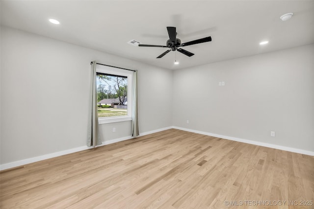 empty room featuring recessed lighting, visible vents, light wood-type flooring, and baseboards