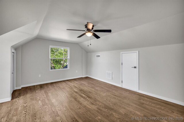 additional living space with visible vents, ceiling fan, wood finished floors, and lofted ceiling