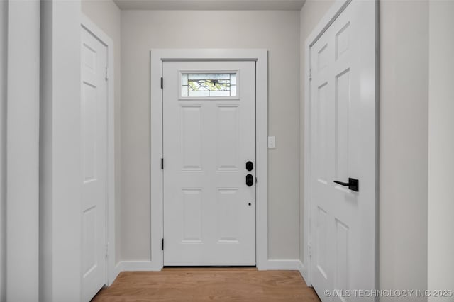 entryway with baseboards and light wood-type flooring