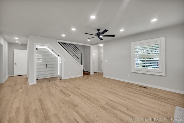 unfurnished living room featuring recessed lighting, stairway, a ceiling fan, light wood-style floors, and visible vents