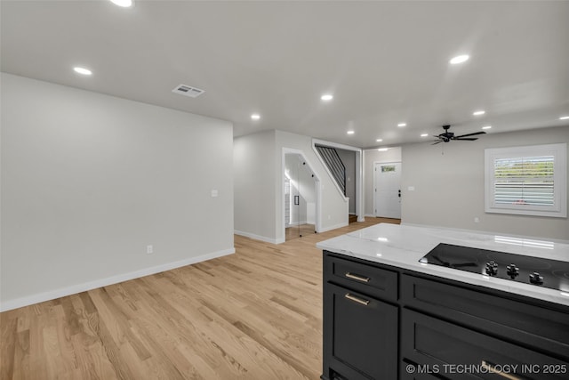 kitchen featuring light wood-type flooring, visible vents, recessed lighting, light stone counters, and black electric cooktop