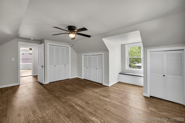additional living space featuring wood finished floors, a healthy amount of sunlight, a ceiling fan, and lofted ceiling