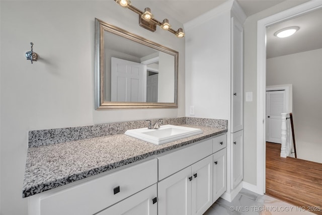 bathroom featuring vanity, marble finish floor, and baseboards
