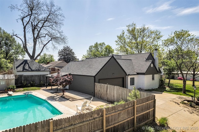 view of swimming pool with a fenced in pool, a patio area, a fenced backyard, and a diving board