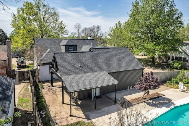 back of house featuring a fenced in pool, a patio, roof with shingles, and fence