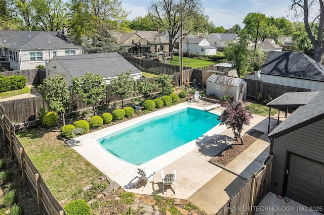 view of pool featuring a residential view, a patio, a fenced backyard, and an outdoor structure