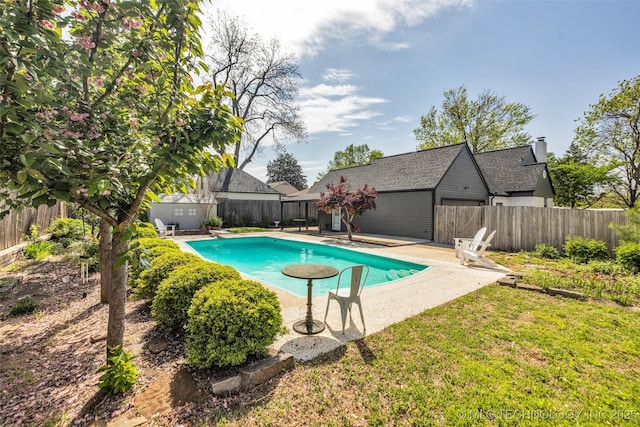 view of swimming pool with an outbuilding, a fenced backyard, and a patio