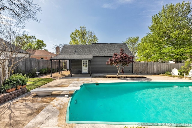 view of swimming pool featuring a fenced in pool, a patio area, a fenced backyard, and a diving board