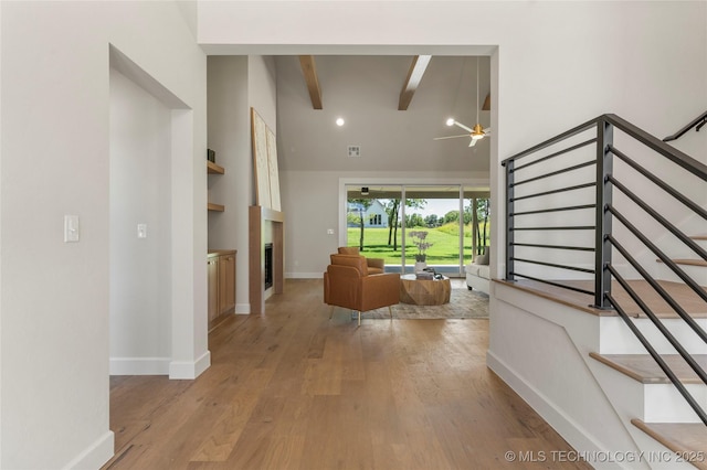 17822 E Patriot Dr, Owasso, OK 74055 - hall featuring high vaulted ceiling, light wood-type flooring, beamed ceiling, and stairs