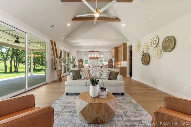 17822 E Patriot Dr, Owasso, OK 74055 - living room featuring a ceiling fan, beamed ceiling, a chandelier, high vaulted ceiling, and wood finished floors