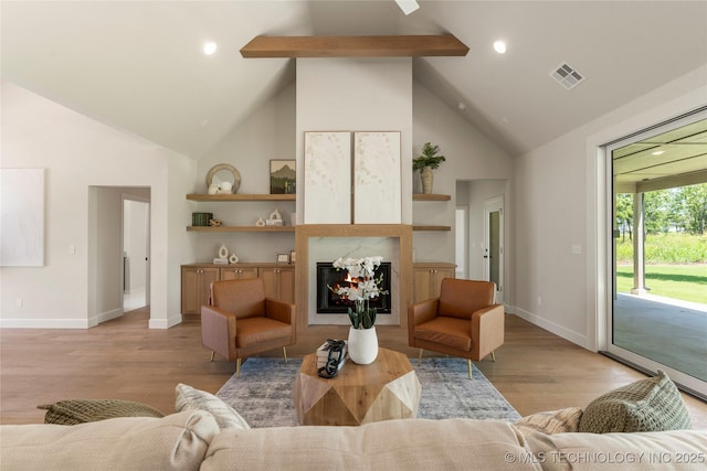 17822 E Patriot Dr, Owasso, OK 74055 - living room with beamed ceiling, light wood-style floors, a glass covered fireplace, high vaulted ceiling, and recessed lighting