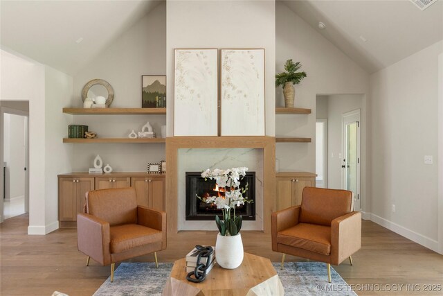 17822 E Patriot Dr, Owasso, OK 74055 - sitting room featuring light wood-style floors, a premium fireplace, and high vaulted ceiling
