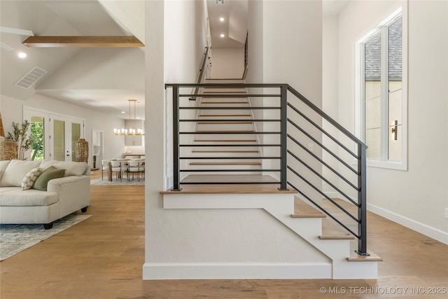 17822 E Patriot Dr, Owasso, OK 74055 - stairs with wood finished floors, high vaulted ceiling, beamed ceiling, a chandelier, and recessed lighting