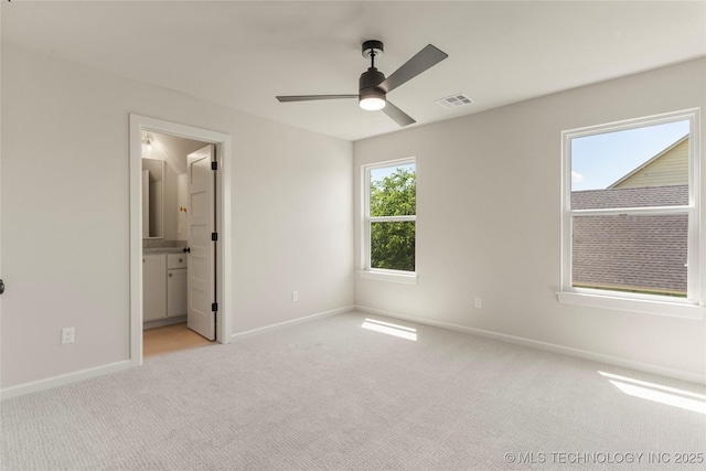 17822 E Patriot Dr, Owasso, OK 74055 - unfurnished bedroom featuring light colored carpet, connected bathroom, and ceiling fan