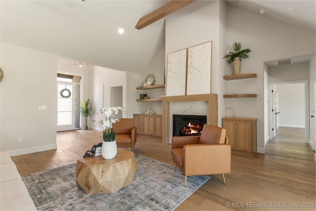 17822 E Patriot Dr, Owasso, OK 74055 - living area featuring high vaulted ceiling, a premium fireplace, wood finished floors, and recessed lighting