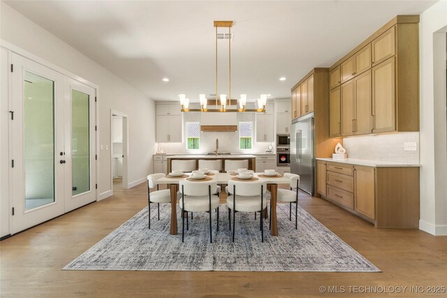 17822 E Patriot Dr, Owasso, OK 74055 - dining area featuring light wood-style floors, recessed lighting, and french doors