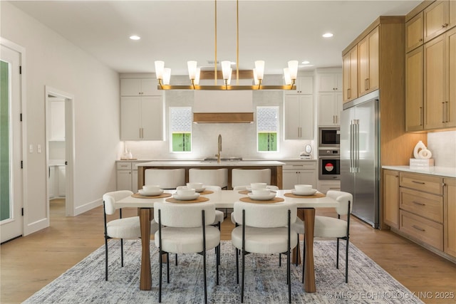 17822 E Patriot Dr, Owasso, OK 74055 - kitchen featuring stainless steel appliances, light wood-style flooring, recessed lighting, backsplash, and pendant lighting