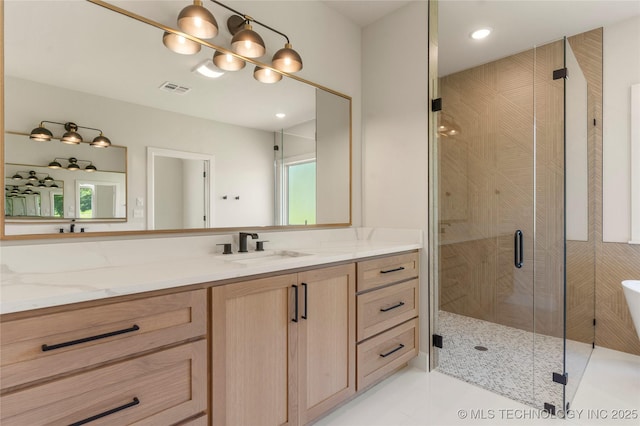 17822 E Patriot Dr, Owasso, OK 74055 - bathroom featuring a freestanding tub, vanity, a stall shower, tile patterned flooring, and recessed lighting