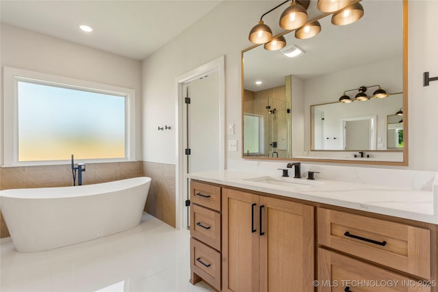 17822 E Patriot Dr, Owasso, OK 74055 - bathroom featuring a shower stall, vanity, a soaking tub, tile patterned floors, and a wainscoted wall