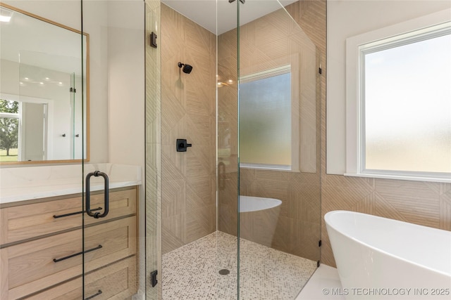 17822 E Patriot Dr, Owasso, OK 74055 - full bathroom featuring a stall shower, a freestanding bath, and vanity