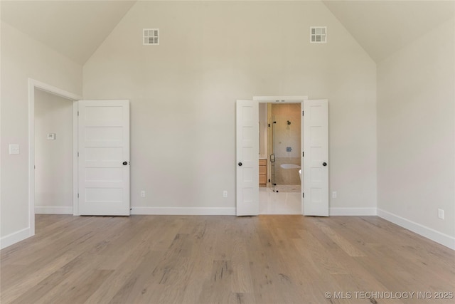 17822 E Patriot Dr, Owasso, OK 74055 - unfurnished bedroom with high vaulted ceiling, light wood-style floors, and connected bathroom