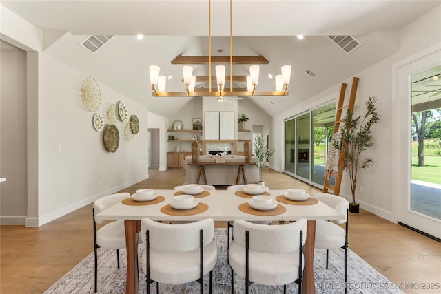 17822 E Patriot Dr, Owasso, OK 74055 - dining room with light wood-style flooring, lofted ceiling, and a chandelier