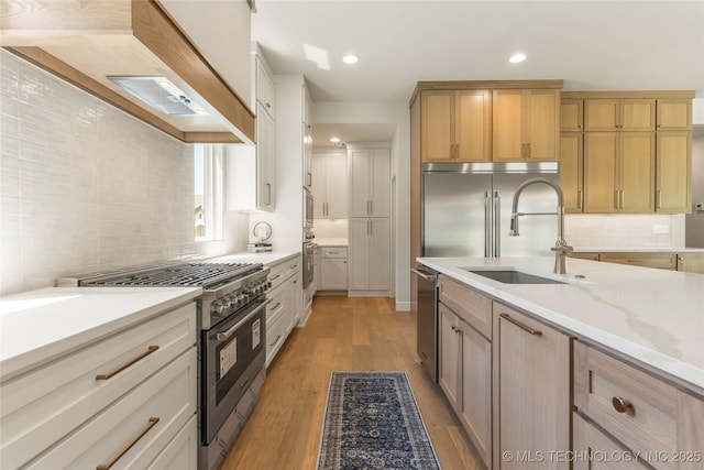 17822 E Patriot Dr, Owasso, OK 74055 - kitchen with high quality appliances, tasteful backsplash, light wood finished floors, light stone countertops, and recessed lighting