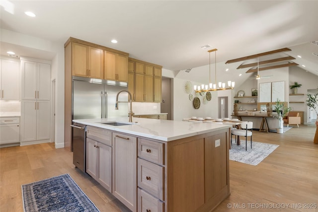 17822 E Patriot Dr, Owasso, OK 74055 - kitchen with light wood-type flooring, recessed lighting, an island with sink, open floor plan, and pendant lighting
