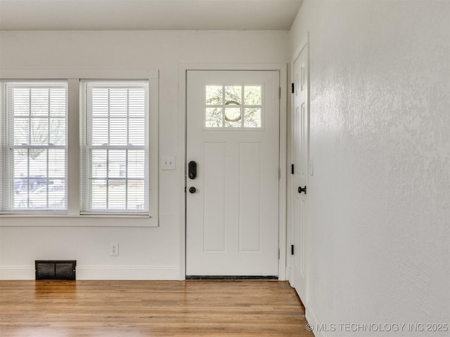 entrance foyer with light wood finished floors and baseboards