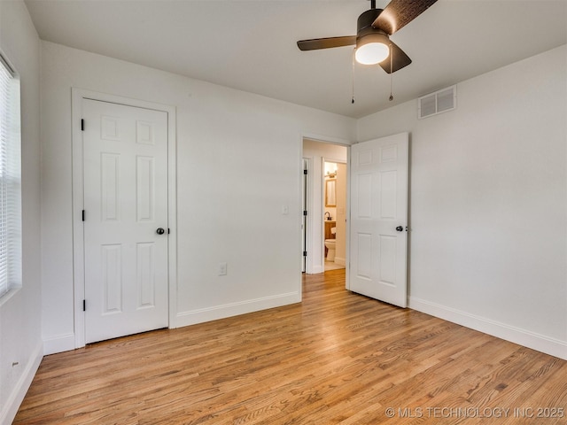 unfurnished bedroom featuring baseboards, visible vents, and light wood-type flooring