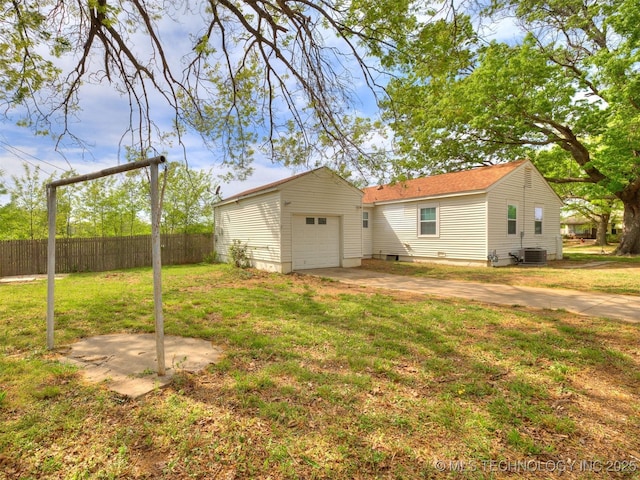 exterior space with fence, driveway, a yard, and central air condition unit
