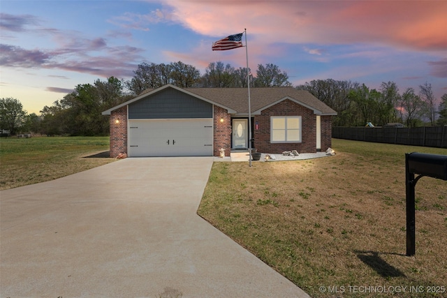 single story home with concrete driveway, a front yard, brick siding, a garage, and fence