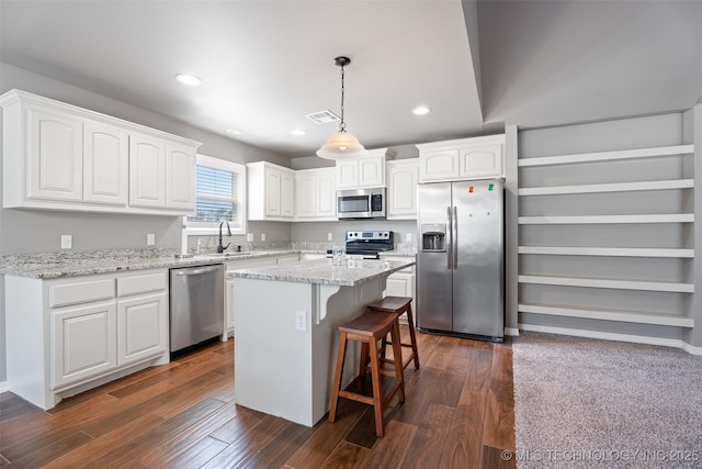 kitchen featuring white cabinets, appliances with stainless steel finishes, a sink, and visible vents