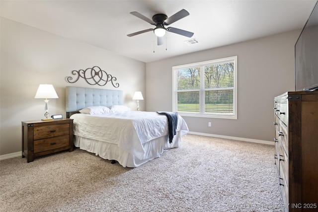 bedroom with visible vents, baseboards, ceiling fan, and light carpet