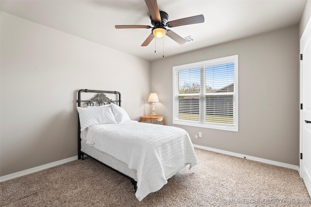 bedroom featuring visible vents, baseboards, and carpet