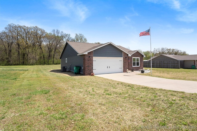 view of property exterior with central air condition unit, a yard, an attached garage, concrete driveway, and brick siding
