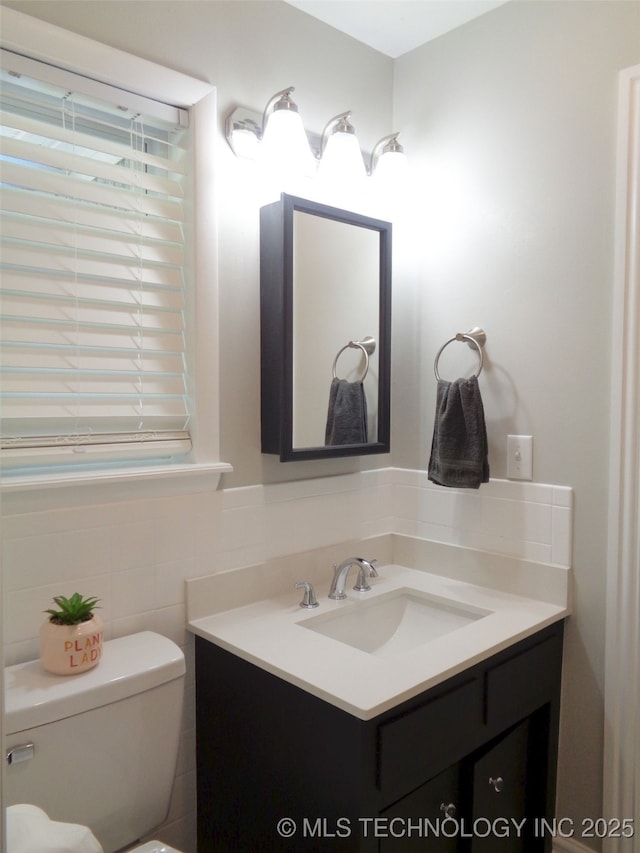 16893 E 116th St N, Owasso, OK 74055 - half bathroom featuring vanity, tile walls, and toilet