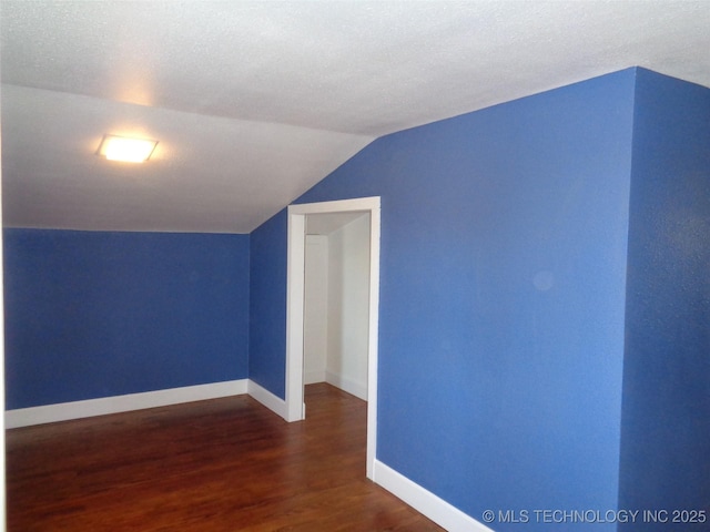 16893 E 116th St N, Owasso, OK 74055 - additional living space featuring dark wood-type flooring, baseboards, and lofted ceiling