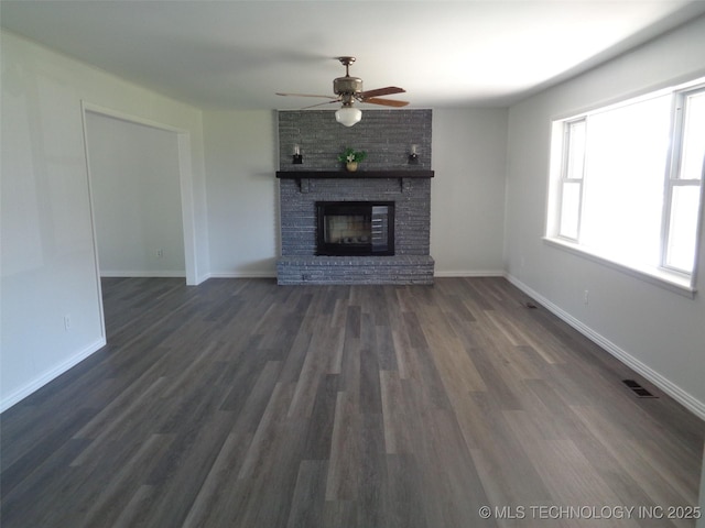 16893 E 116th St N, Owasso, OK 74055 - unfurnished living room with visible vents, baseboards, a ceiling fan, a fireplace, and dark wood-type flooring