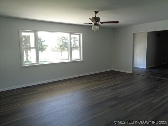 16893 E 116th St N, Owasso, OK 74055 - unfurnished bedroom featuring a ceiling fan, baseboards, dark wood-style floors, and visible vents