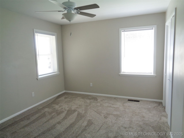 16893 E 116th St N, Owasso, OK 74055 - empty room with ceiling fan, baseboards, visible vents, and carpet floors