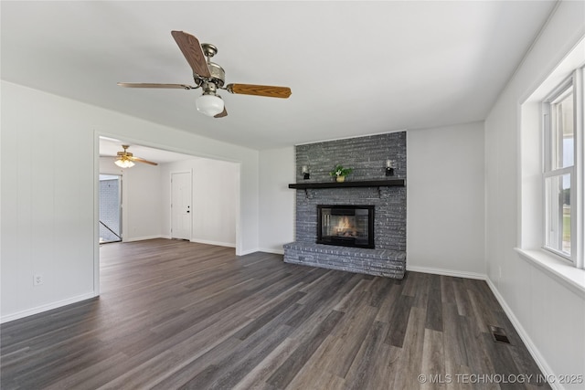 16893 E 116th St N, Owasso, OK 74055 - unfurnished living room with wood finished floors, a fireplace, and a ceiling fan