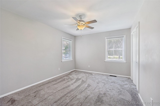 16893 E 116th St N, Owasso, OK 74055 - unfurnished room with healthy amount of natural light, carpet flooring, and ceiling fan
