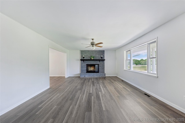 16893 E 116th St N, Owasso, OK 74055 - unfurnished living room featuring a ceiling fan, wood finished floors, and a fireplace