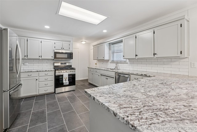 16893 E 116th St N, Owasso, OK 74055 - kitchen with stainless steel appliances, backsplash, light stone countertops, dark tile patterned flooring, and recessed lighting