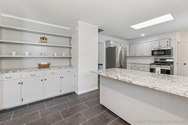 16893 E 116th St N, Owasso, OK 74055 - kitchen featuring stainless steel appliances, light stone counters, decorative backsplash, dark tile patterned floors, and ornamental molding